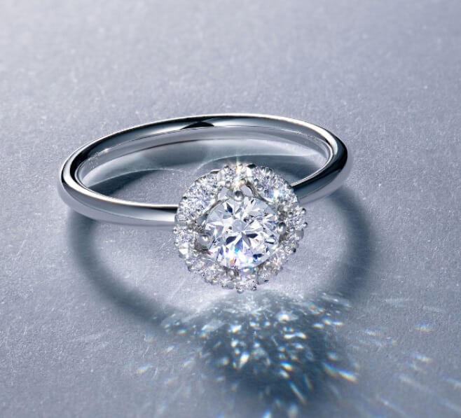 A diamond ring with a halo surrounded by diamonds.