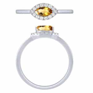 A white gold ring with a citrine stone and diamonds.