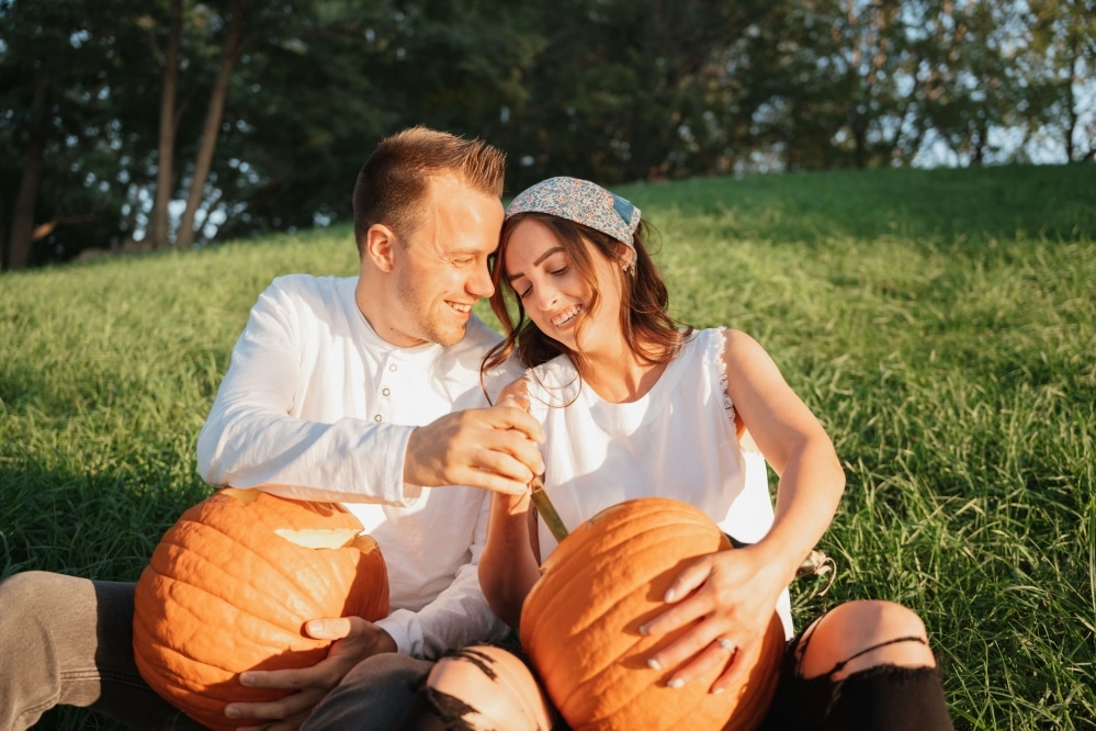 Couple carving pumpkins.