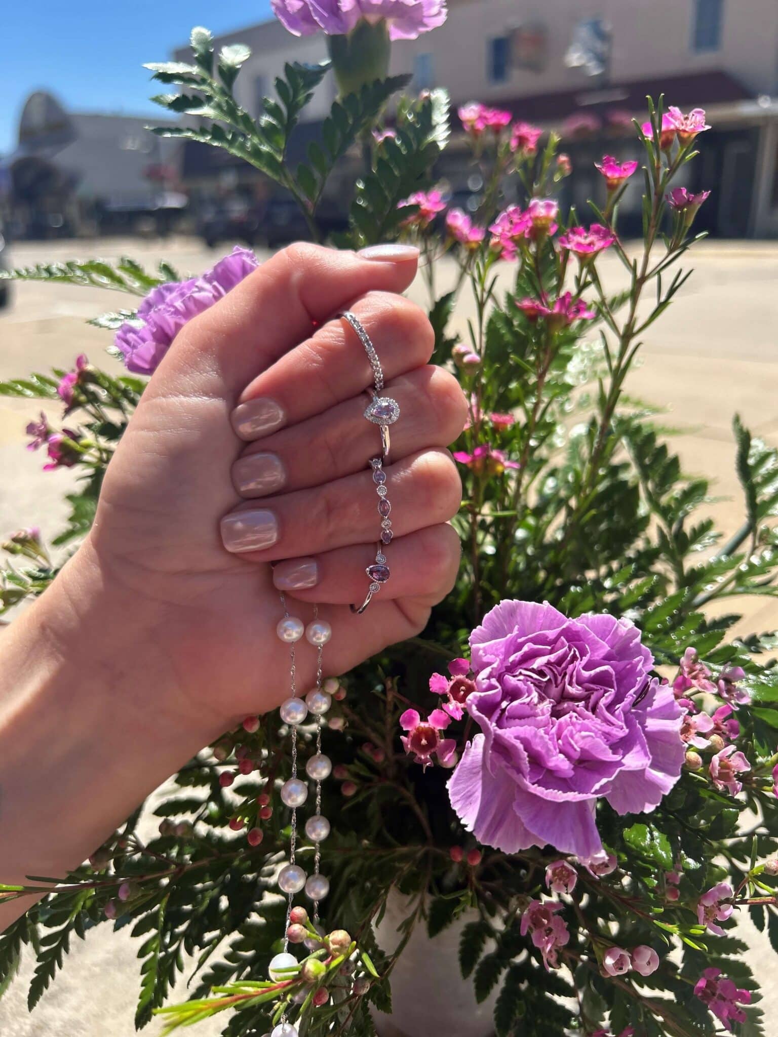 Woman's hand wearing alexandrite and pearl jewelry